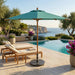 Midtown Bamboo umbrella with a teal Sunbrella canopy beside an infinity pool