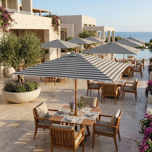 Midtown Bamboo umbrellas with striped Sunbrella canopies over a restaurant terrace