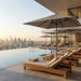Midtown Bamboo umbrella over loungers at a rooftop pool